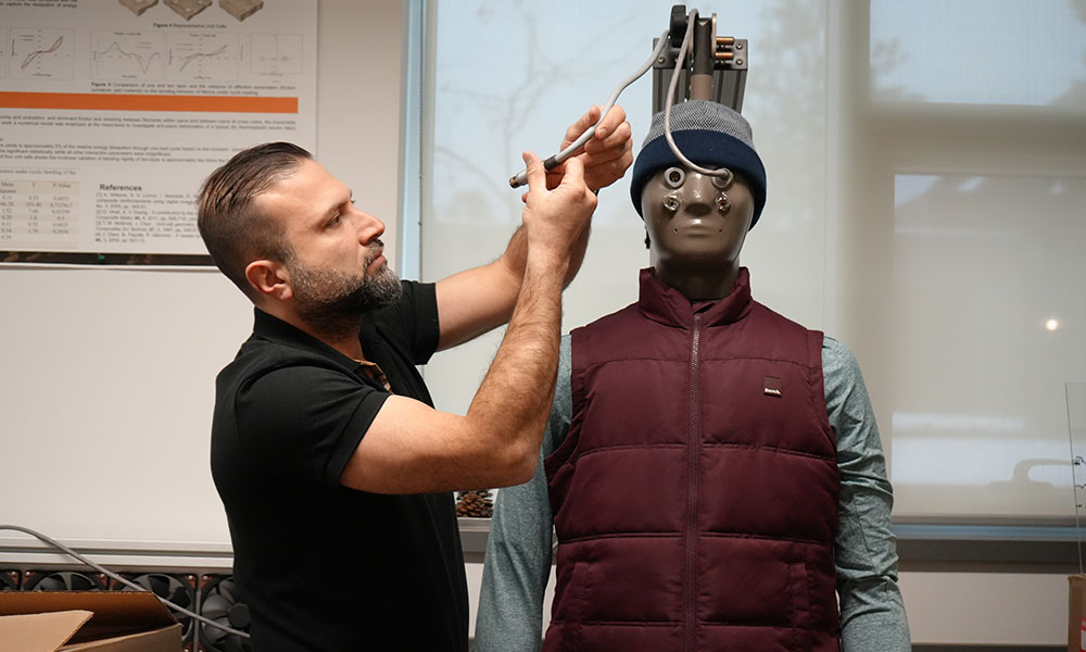 A photo of a researcher working with a thermal manikin.