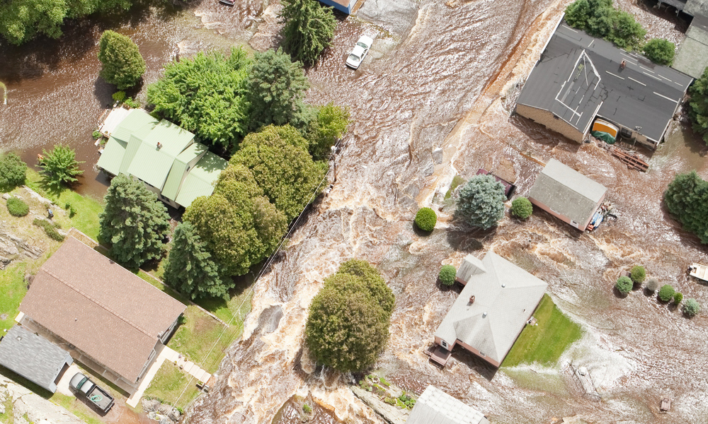 An aerial view of homes surrounded by flood waters