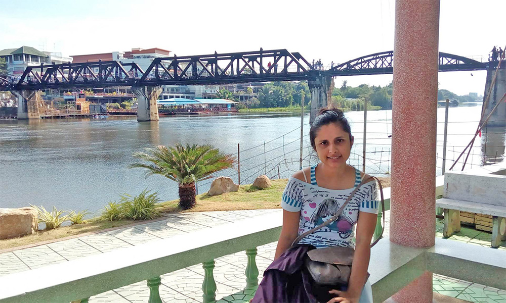 Akanksha Bhurtel in front of a railway bridge