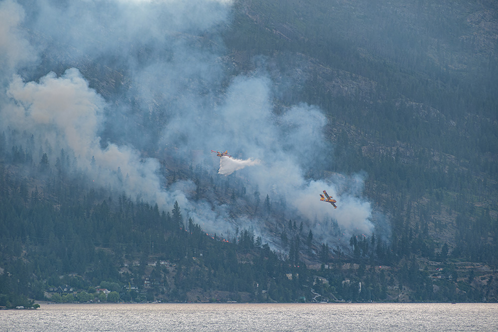 A photo of wildfire suppression planes working on a fire in the Okanagan valley
