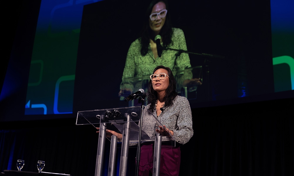 A photo of Wendy Wong speaking to an audience. 
