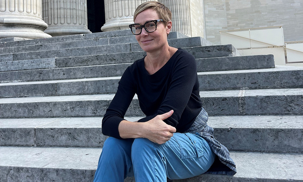 A photo of author Shelley Wood sitting on some stone steps