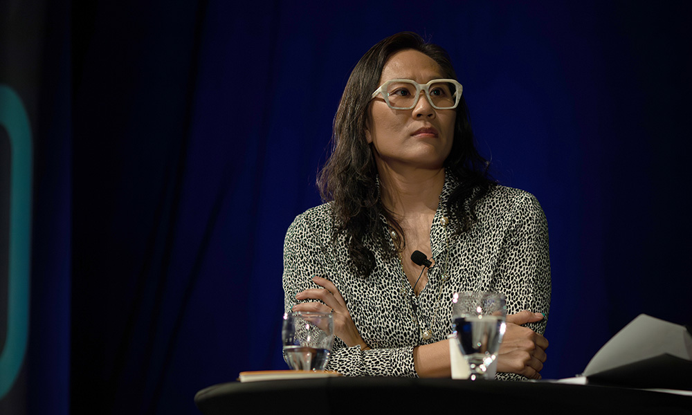 Dr. Wendy Wong sits and listens during a debate about artificial intelligence