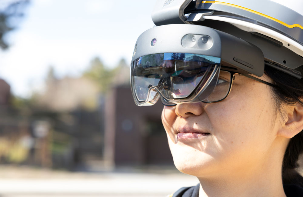 A close-up of the VR lenses worn by Dr. Qian Chen. The lenses are black and cover her regular glasses.