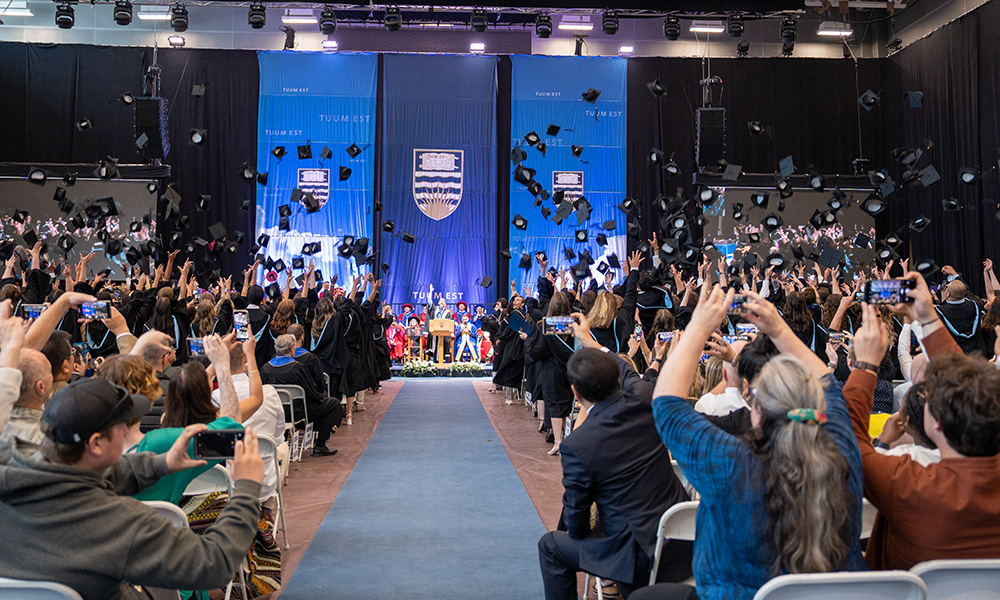 A photo of UBCO graduates tossing their caps