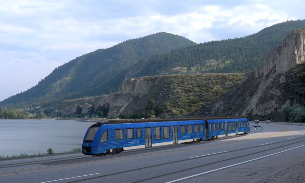 An artist's conception of a blue electric tram travelling alongside Okanagan Lake. 