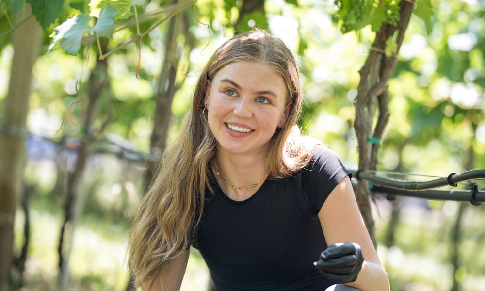 A close-up of Brooklyn Becker in the vineyard