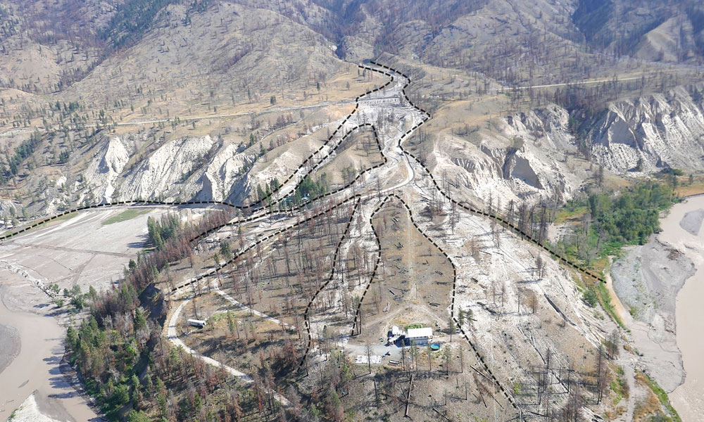 An aerial photo of the MacDonalds' property after the post-wildfire debris flows. A black dotted line is seen throughout the photo, showing the flow of debris.