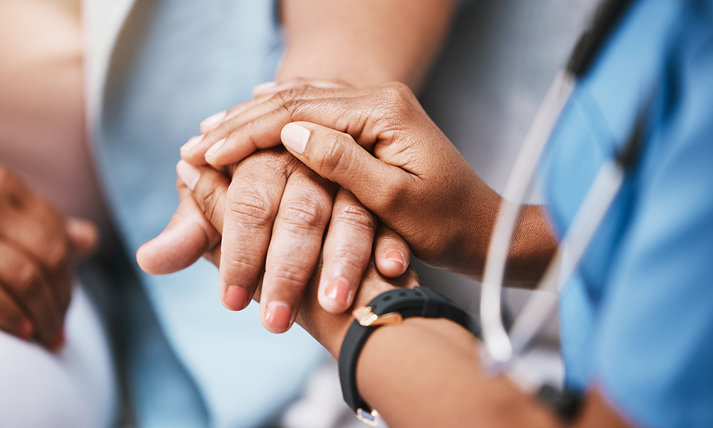 Nurse holding hands with patient for help, consulting support and healthcare advice. Kindness, counseling and medical therapy in nursing home for hope, consultation and psychology.